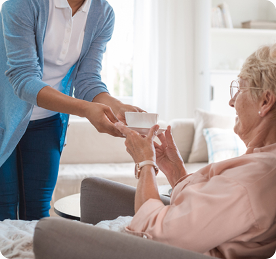 Compassionate caregiver assisting elderly person with in-home aged care