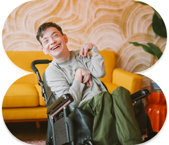 Caregiver assisting NDIS participant in wheelchair with daily activities
