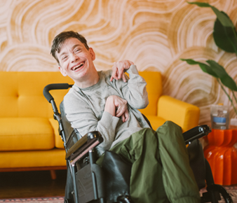 NDIS caregiver helping person in wheelchair with daily living tasks