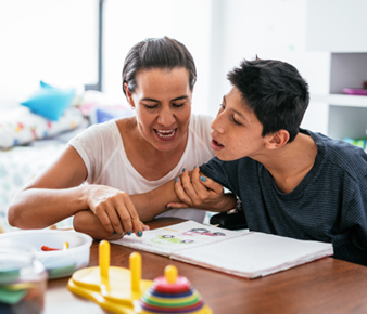 NDIS participant learning daily life skills with support from a care worker